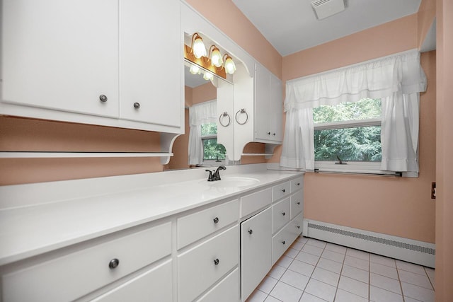 bathroom with tile patterned floors, visible vents, a healthy amount of sunlight, and baseboard heating