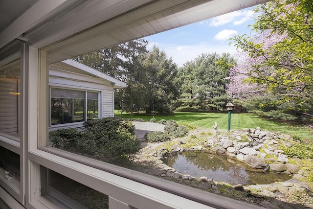 exterior space with a garden pond