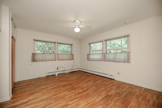 unfurnished room with light wood-type flooring, a ceiling fan, and baseboards