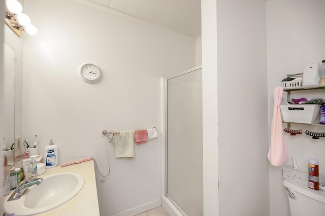 bathroom with vanity, crown molding, toilet, and a shower stall