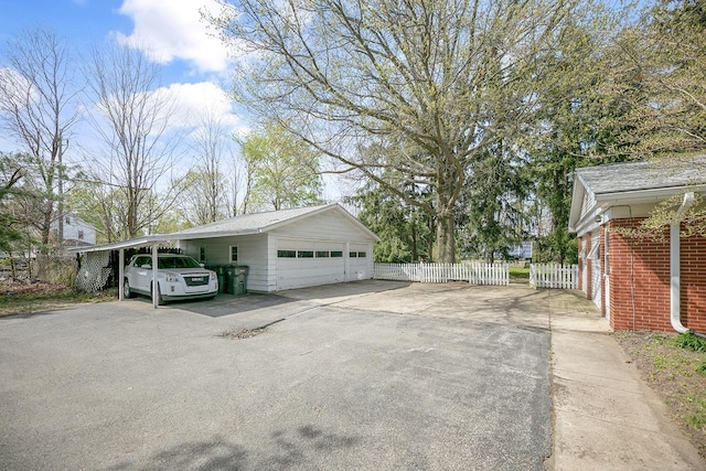 exterior space featuring fence and a detached garage