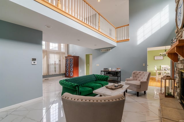 68106 Telegraph Ct, Lakeville, IN 46536 - living room with baseboards, marble finish floor, a towering ceiling, and visible vents