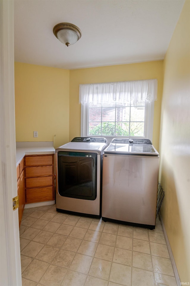68106 Telegraph Ct, Lakeville, IN 46536 - laundry area with cabinet space, light tile patterned flooring, and washer and clothes dryer