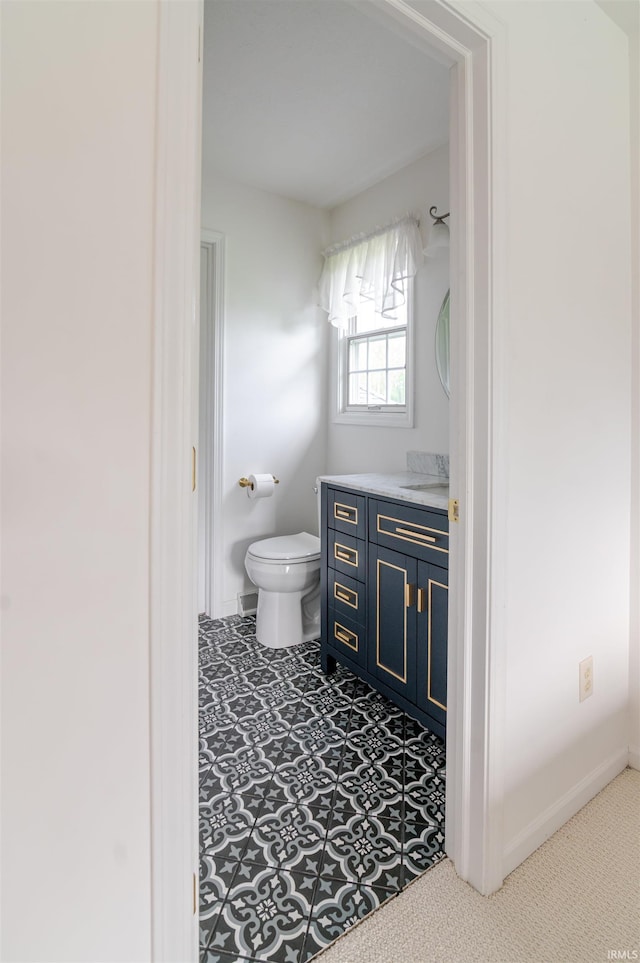 68106 Telegraph Ct, Lakeville, IN 46536 - bathroom featuring toilet, baseboards, and vanity