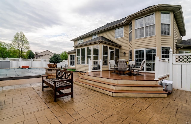 68106 Telegraph Ct, Lakeville, IN 46536 - back of house with fence, a sunroom, a deck, outdoor dining area, and a patio area