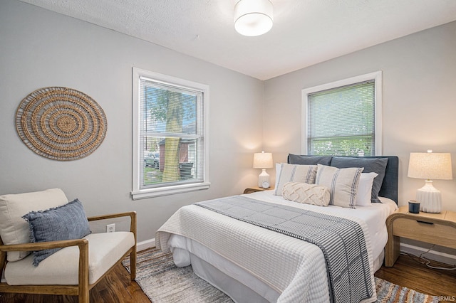bedroom featuring baseboards and wood finished floors