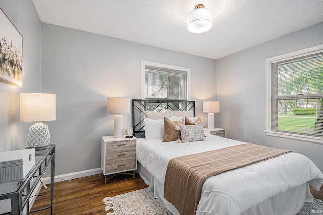 bedroom featuring baseboards and wood finished floors