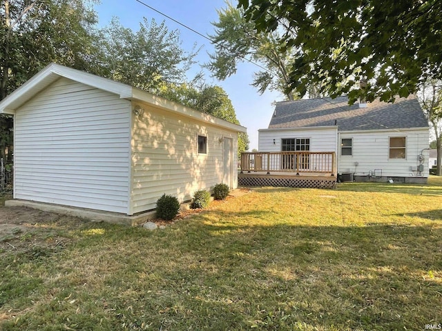 back of property featuring a lawn and a deck