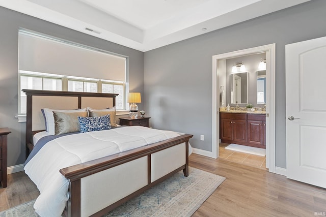 54637 Burdette St Unit 2, South Bend, IN 46637 - bedroom featuring visible vents, light wood-style floors, ensuite bathroom, and baseboards