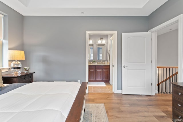 54637 Burdette St Unit 2, South Bend, IN 46637 - bedroom featuring light wood-style flooring and connected bathroom