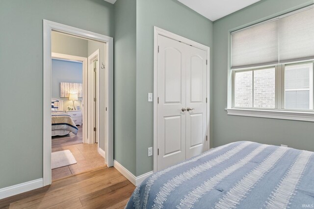 54637 Burdette St Unit 2, South Bend, IN 46637 - bedroom featuring baseboards, wood finished floors, and a closet