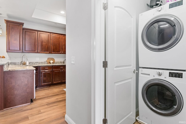 54637 Burdette St Unit 2, South Bend, IN 46637 - laundry area with laundry area, stacked washing maching and dryer, recessed lighting, a sink, and light wood-style flooring