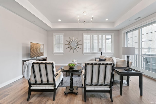 54637 Burdette St Unit 2, South Bend, IN 46637 - living area featuring a raised ceiling, a chandelier, wood finished floors, and visible vents