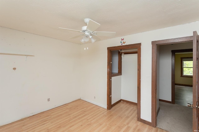 unfurnished room with light wood-style floors, baseboards, and ceiling fan