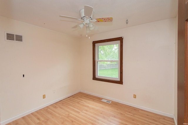 empty room featuring baseboards, visible vents, and light wood-type flooring