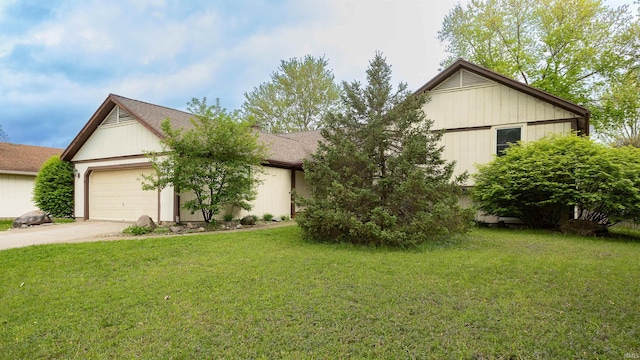 view of front of property with an attached garage, concrete driveway, and a front yard