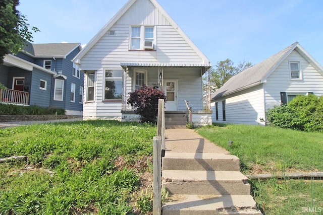 2813 W Franklin St, Evansville, IN 47712 - bungalow with board and batten siding, covered porch, and cooling unit