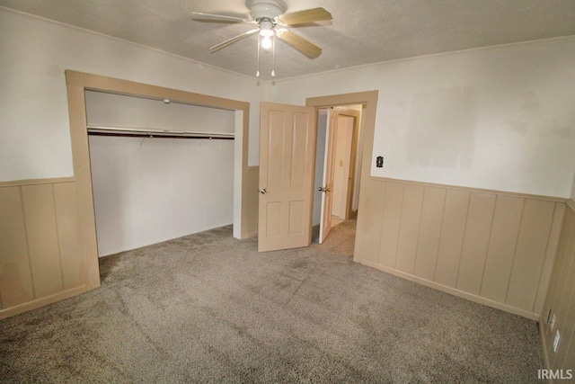 2813 W Franklin St, Evansville, IN 47712 - unfurnished bedroom featuring carpet floors, a ceiling fan, a wainscoted wall, and a closet