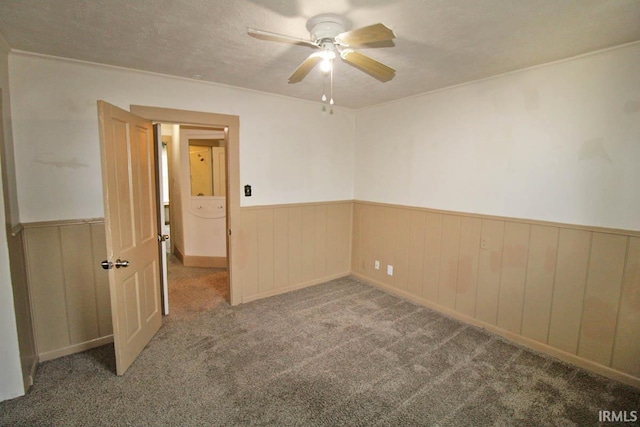 2813 W Franklin St, Evansville, IN 47712 - carpeted empty room featuring ceiling fan and wainscoting