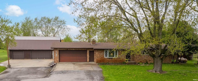 2877 County Road 36, Auburn, IN 46706 - ranch-style home featuring a chimney, a garage, brick siding, a front lawn, and concrete driveway