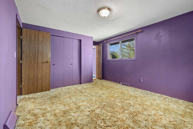 2877 County Road 36, Auburn, IN 46706 - unfurnished bedroom featuring carpet floors, a closet, a textured ceiling, and visible vents