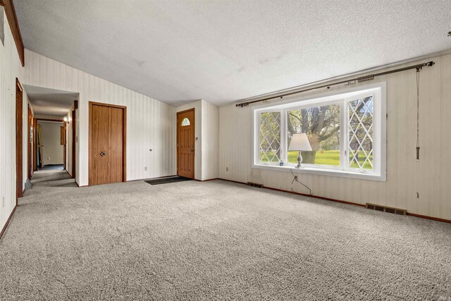 2877 County Road 36, Auburn, IN 46706 - interior space with carpet, lofted ceiling, a textured ceiling, and visible vents