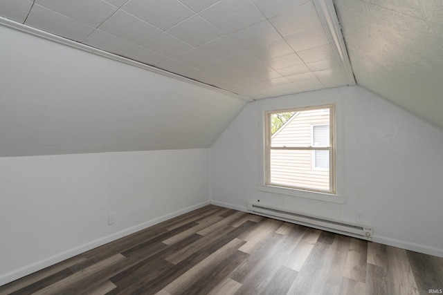 bonus room featuring vaulted ceiling, baseboards, a baseboard heating unit, and wood finished floors