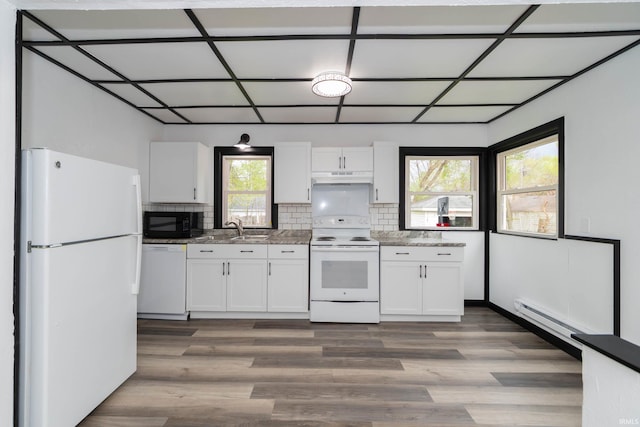 kitchen featuring white cabinets, baseboard heating, white appliances, wood finished floors, and under cabinet range hood