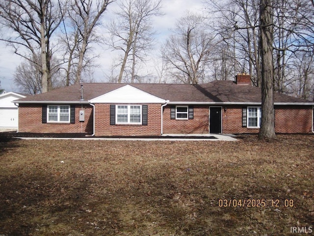 ranch-style home with brick siding and a chimney