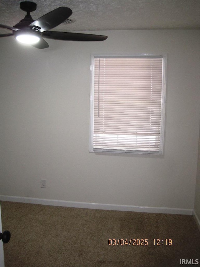 carpeted empty room with baseboards and ceiling fan