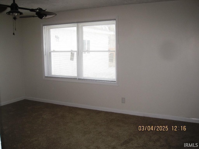 carpeted empty room with baseboards and ceiling fan