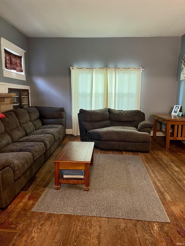 living room with wood-type flooring and baseboards