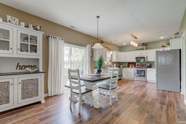 dining area featuring visible vents, recessed lighting, and dark wood-style floors