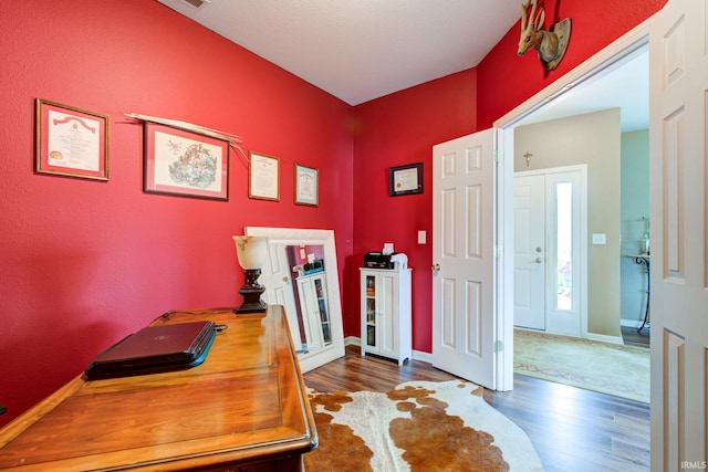 office area featuring baseboards and wood finished floors