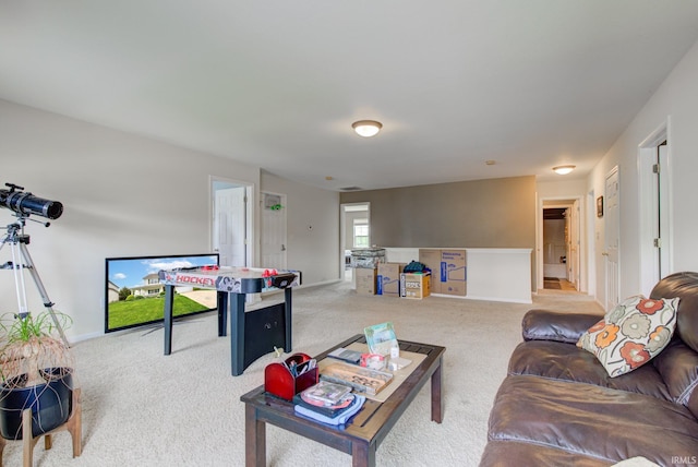 carpeted living room featuring baseboards