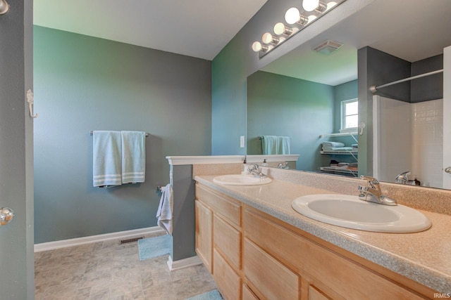 full bath featuring a sink, walk in shower, double vanity, and visible vents