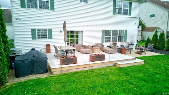 rear view of house featuring a yard, a patio area, and an outdoor living space with a fire pit