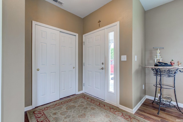 entryway with baseboards, plenty of natural light, and wood finished floors