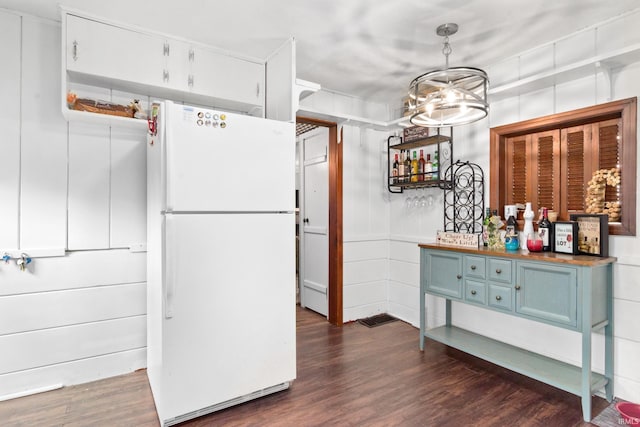 1901 Keck Ave, Evansville, IN 47711 - kitchen with freestanding refrigerator, dark wood-style flooring, blue cabinetry, and a notable chandelier