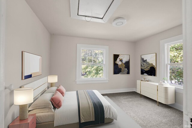 carpeted bedroom featuring baseboards and attic access
