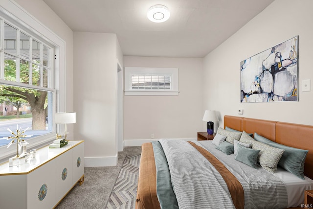 bedroom featuring baseboards and light colored carpet