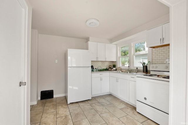 kitchen with white cabinets, a sink, white appliances, light countertops, and tasteful backsplash