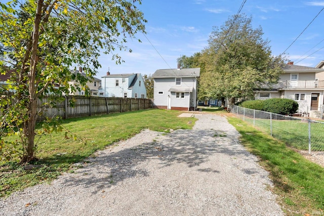 exterior space featuring a fenced backyard and driveway