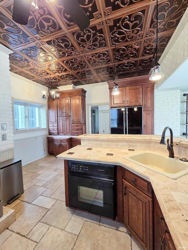 1106 E 5th St, Fowler, IN 47944 - kitchen featuring a sink, light countertops, an ornate ceiling, black appliances, and stone tile floors