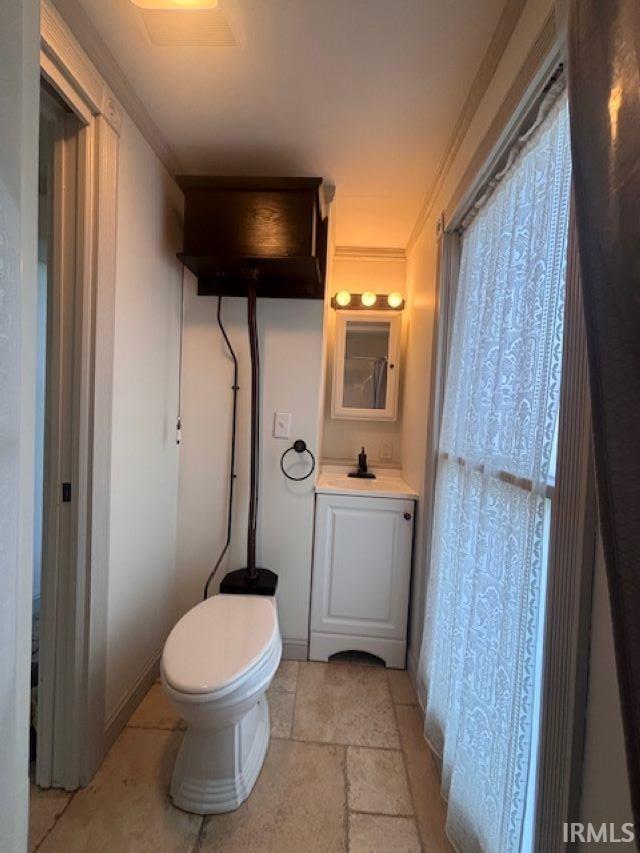 1106 E 5th St, Fowler, IN 47944 - half bathroom with vanity, stone tile floors, and toilet