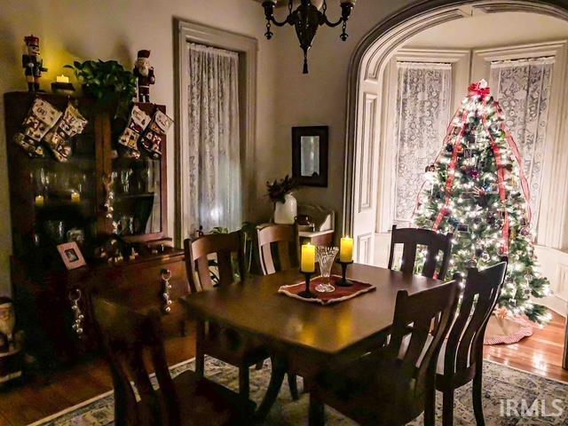 1106 E 5th St, Fowler, IN 47944 - dining space featuring arched walkways, wood finished floors, and a chandelier