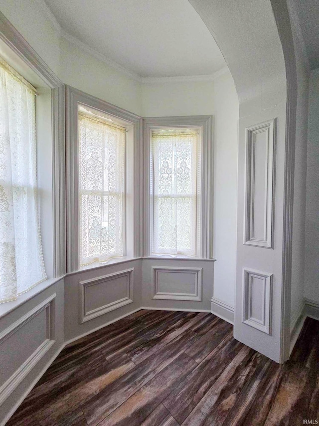 1106 E 5th St, Fowler, IN 47944 - unfurnished room featuring crown molding, dark wood-style flooring, and arched walkways