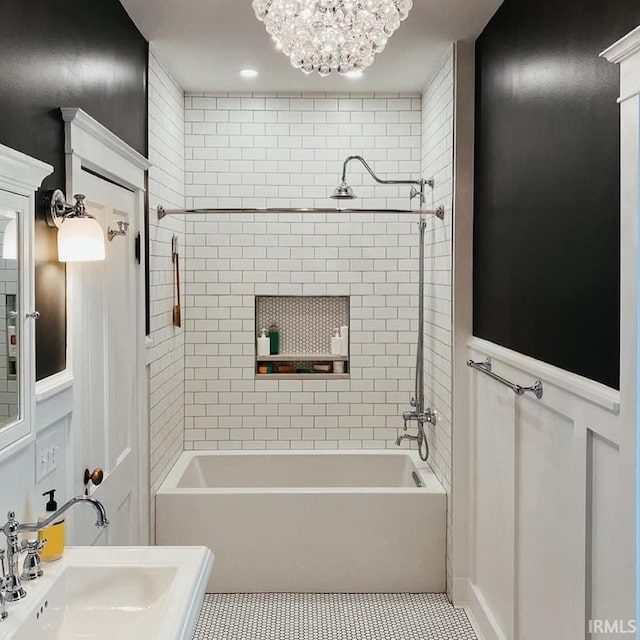 1106 E 5th St, Fowler, IN 47944 - bathroom with a notable chandelier, wainscoting, a sink, tile patterned flooring, and tub / shower combination