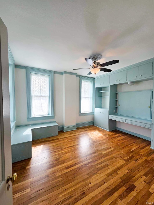1106 E 5th St, Fowler, IN 47944 - unfurnished bedroom featuring baseboards, a ceiling fan, and wood finished floors
