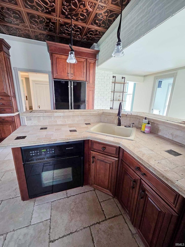 1106 E 5th St, Fowler, IN 47944 - kitchen featuring a sink, hanging light fixtures, black appliances, and stone tile floors